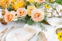 09 The wedding tablescape was done with a wooden charger, pastel plates and bright blooms and greenery