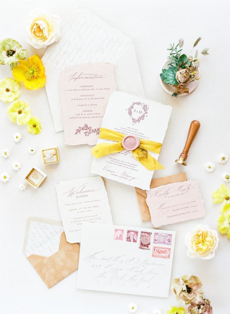 The wedding invitation suite was done with neutrals, blush and seals and bright ribbons