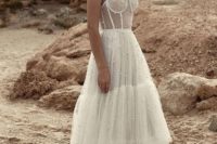 11 a gorgeous wedding dress, fully embellished with pearls, with a bustier bodice and a layered tulle skirt