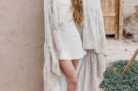 13 white leather booties, a white plain mini dress and a lace capelet with a train for a trendy modern look with a touch of boho
