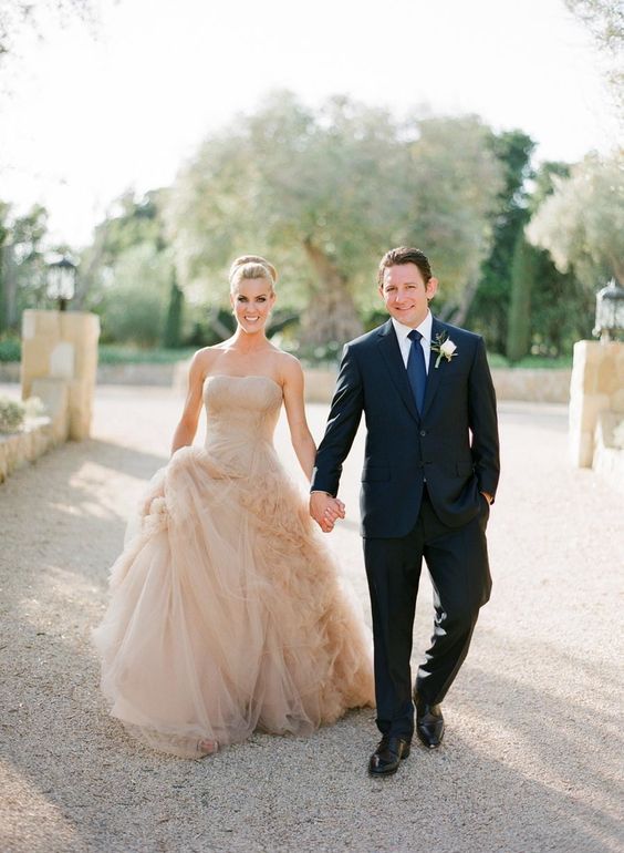 a chic wedding ballgown in tan shades, with a strapless neckline and a tiered tulle skirt for a classic feel