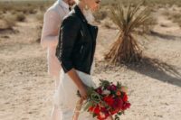 23 a lace wedding dress, silver boots, a black leather jacket and statement boho earrings for an ultimate bridal look