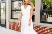 a casual midi white dress with a V-neckline, short sleeves and nude shoes plus a neutral bag for a summer bridal shower
