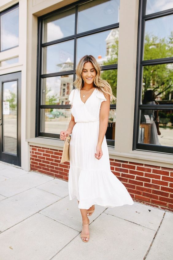 A casual midi white dress with a V neckline, short sleeves and nude shoes plus a neutral bag for a summer bridal shower