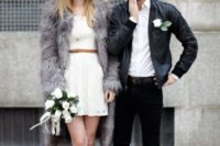 a lace mini dress with a brown belt, grey shoes and a grey faux fur coat for a modern bride