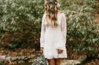 a mini lace A-line wedding dress with a V-neckline and bell sleeves for a woodland boho bride