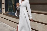 a plain white midi shirtdress with buttons, white flipflops with heels and a white bag for a summer bridal shower