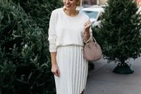 a stylish and casual look with a white top, a pleated asymmetrical midi, dusty pink shoes and a matching bag