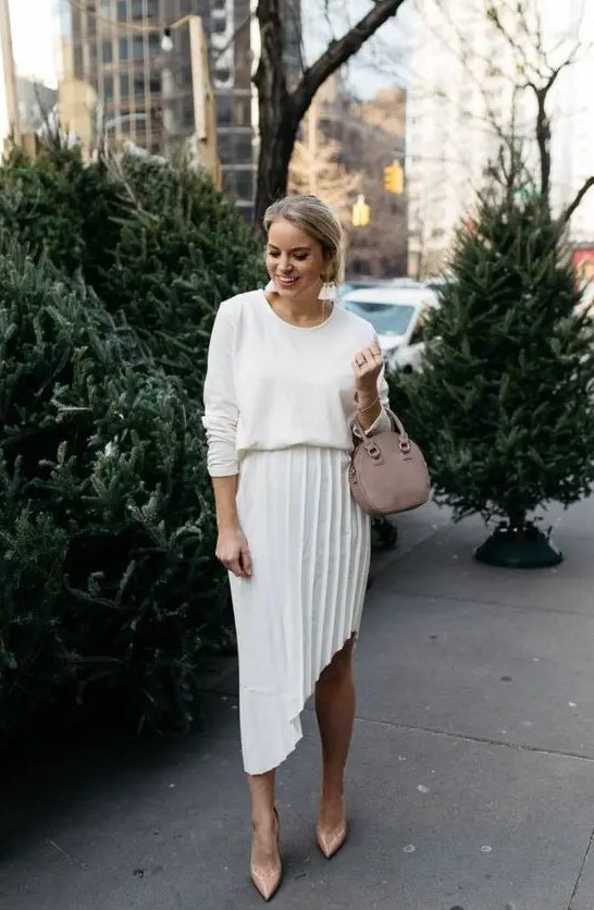 a stylish and casual look with a white top, a pleated asymmetrical midi, dusty pink shoes and a matching bag