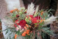 02 The wedding bouquet was done in red and burgundy, with greenery and spikes