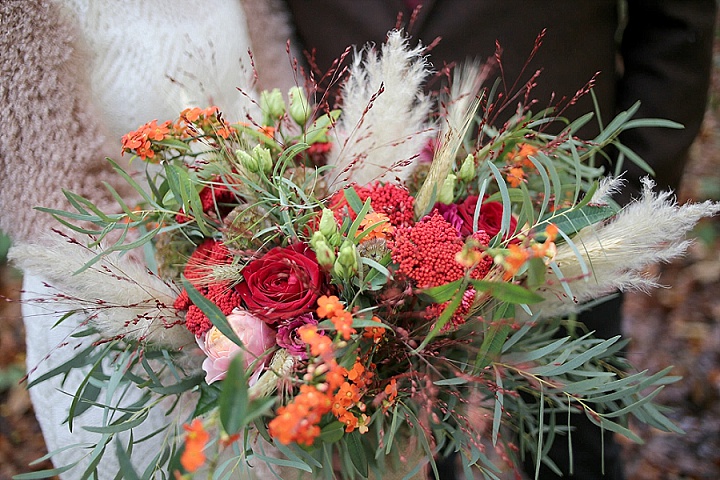 The wedding bouquet was done in red and burgundy, with greenery and spikes
