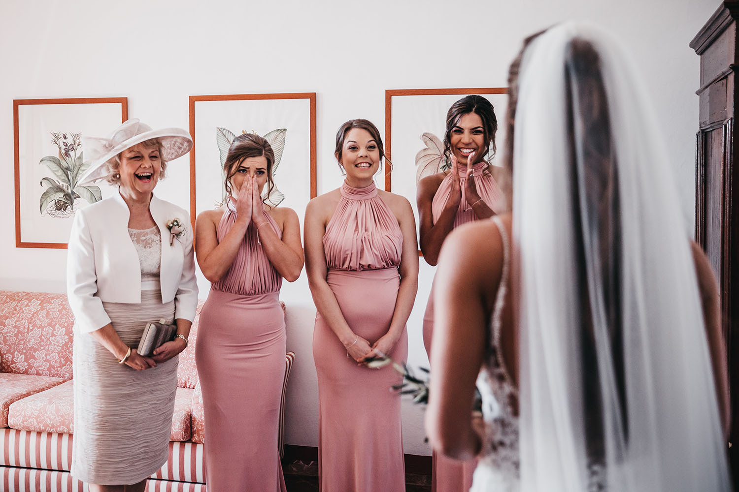 The bridesmaids were rocking matching halter neckline pink maxi dress with draped bodices