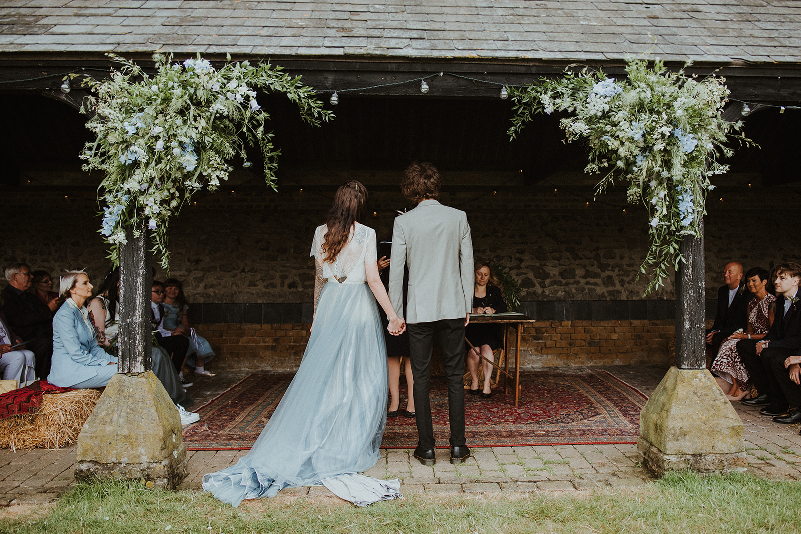 The wedding ceremony was simple and sweet, with blue blooms and greenery