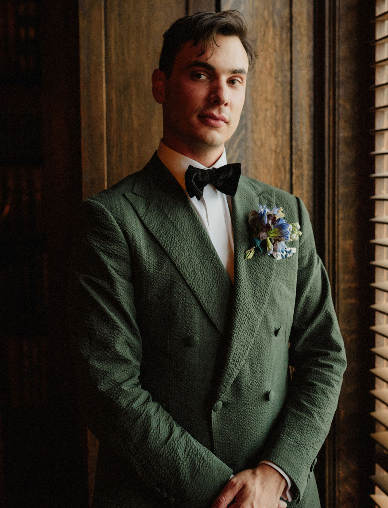 The groom was rocking a creative green suit, a dark velvet bow tie and a bold boutonniere