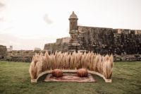04 The wedding ceremony space was done with pampas grass, boho rugs and leather ottomans