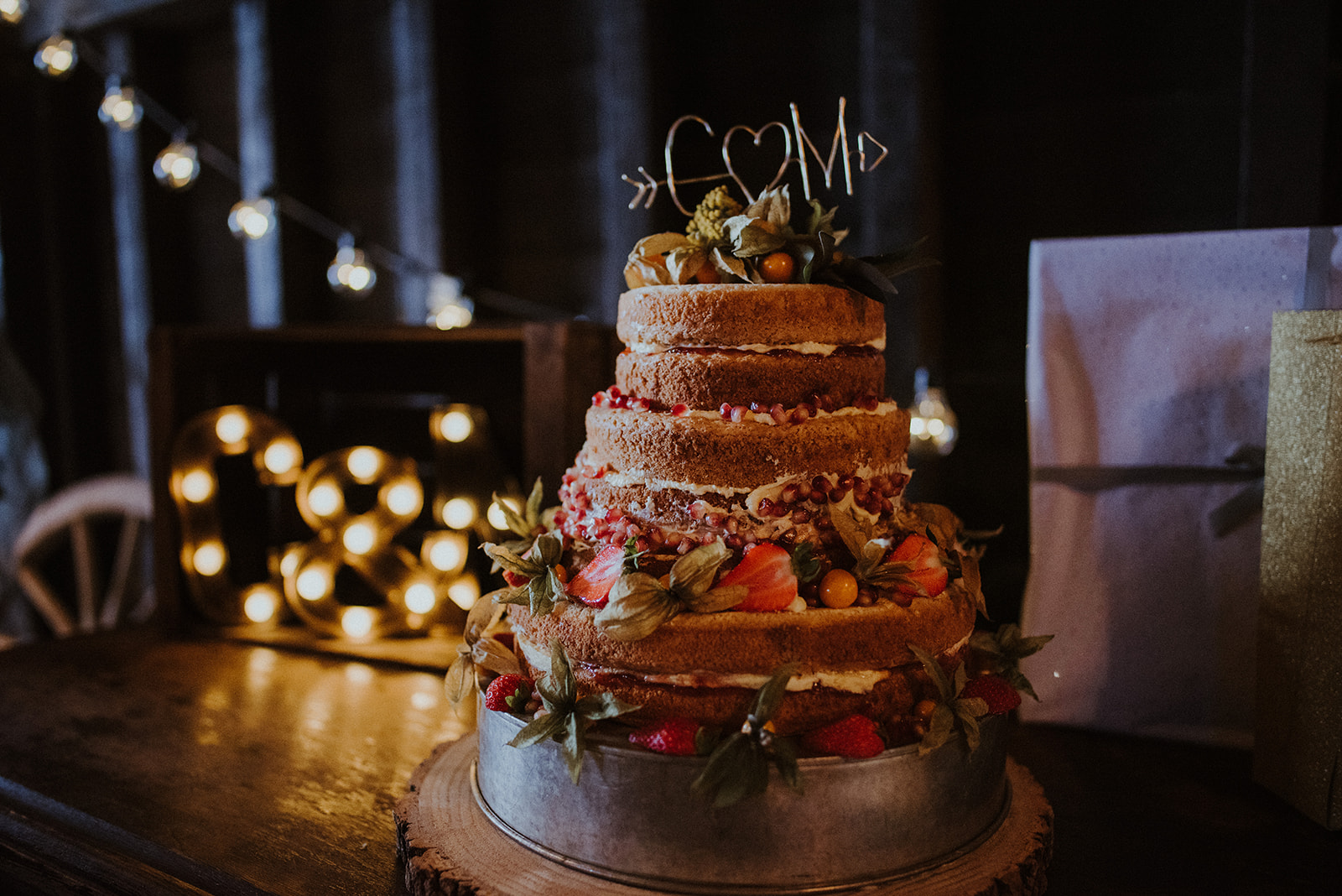 The wedding cake was a naked one decorated with fresh fruits and blooms