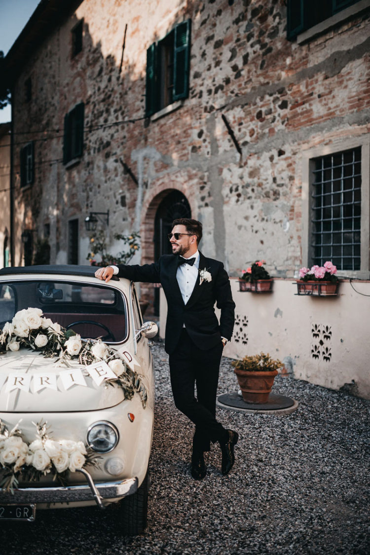 The couple decorated an old Fiat with blooms for their weddign escape