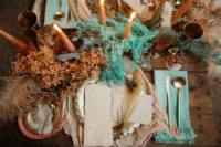 06 The reception table was styled with the same grasses and feathers, candles and colorful napkins