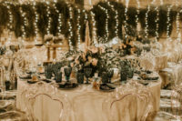 06 The wedding reception was outdoors, with neutral blooms and greenery and cool ghost chairs