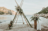 06 This teepee was renovated into an arch with greenery, blooms and pampas grass plus an altar with an arrangement