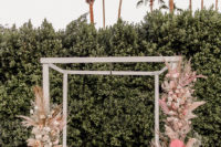 07 The wedding arch was done with pink fronds, pampas grass and blush blooms