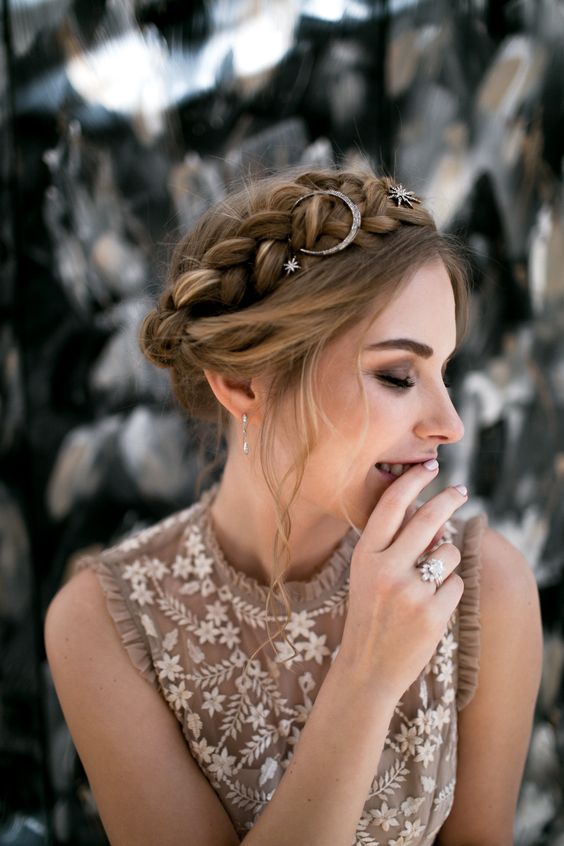 a halo braided updo with some locks down and star hair pins and a moon one for a boho touch