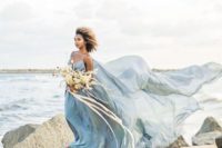 07 a super airy blue spaghetti strap wedding dress with a train will make a statement on any coast