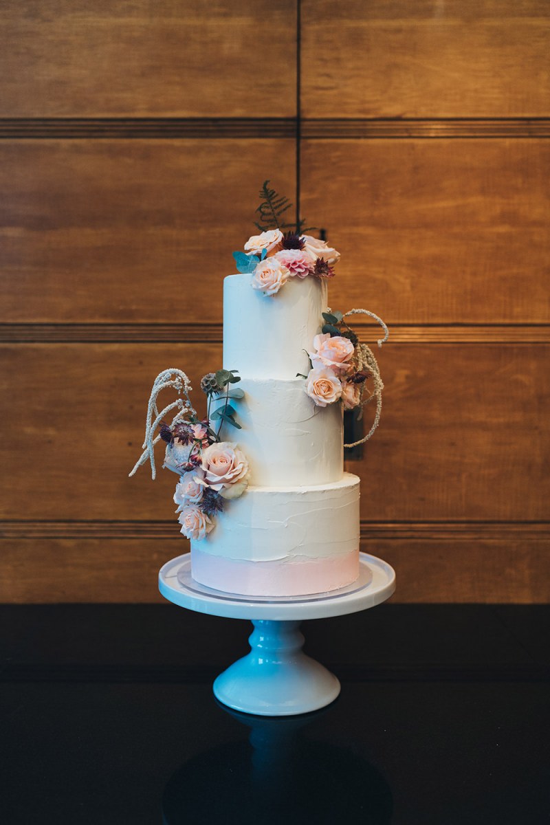 The wedding cake was a white textural one, with blush blooms and greenery