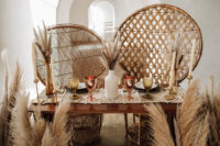 09 The table was styled with a macrame runner, bright glasses, feathers and pampas grass