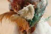 10 The wedding bouquet was done with spary painted grasses and feathers