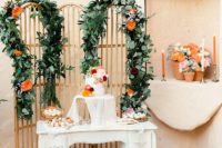 11 The sweets table features some delicious desserts and a pretty wedding cake with blooms
