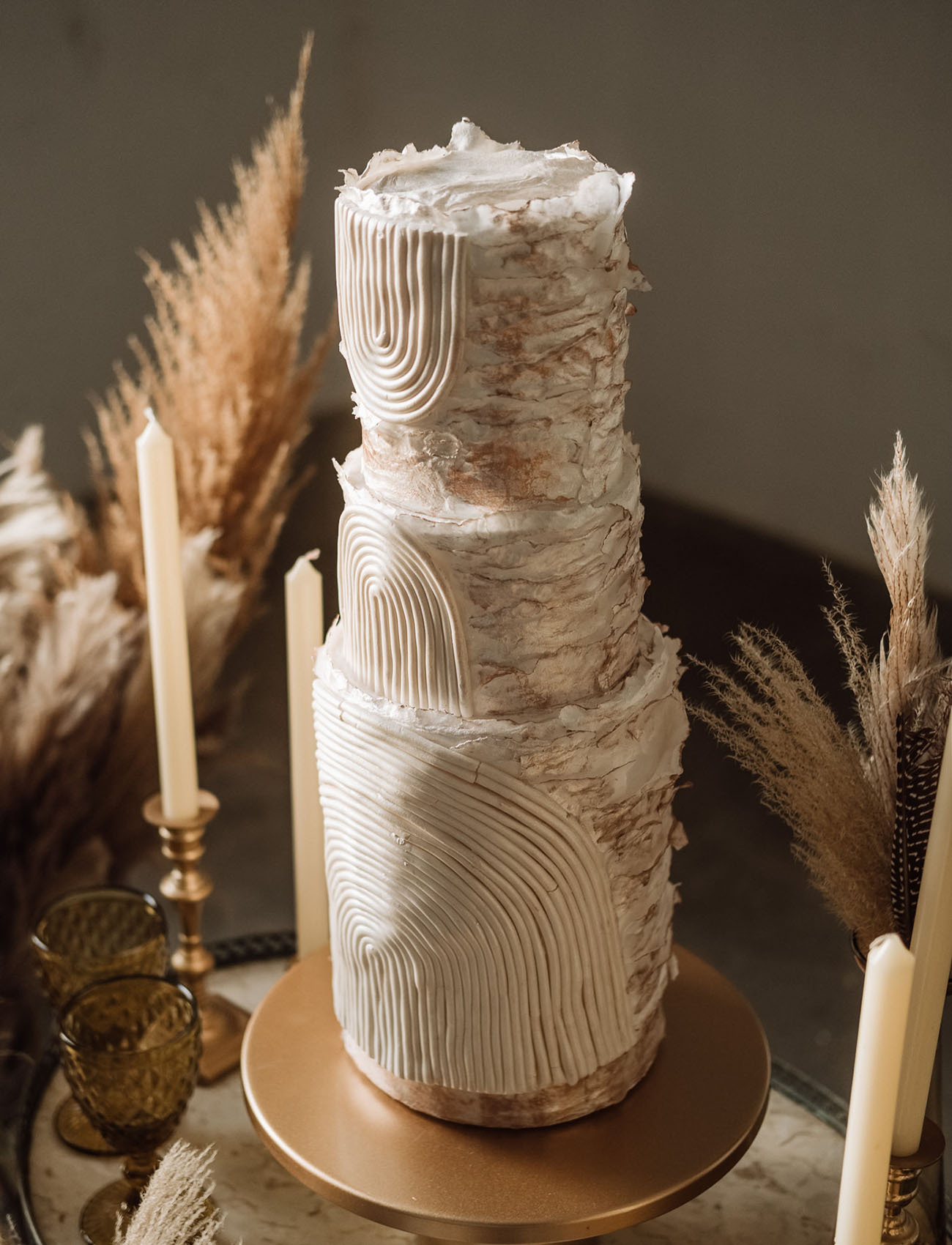 The wedding cake was a unique white textural one on a gold stand