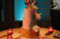 11 The wedding cake was pink and amber, with large tropical blooms and greenery