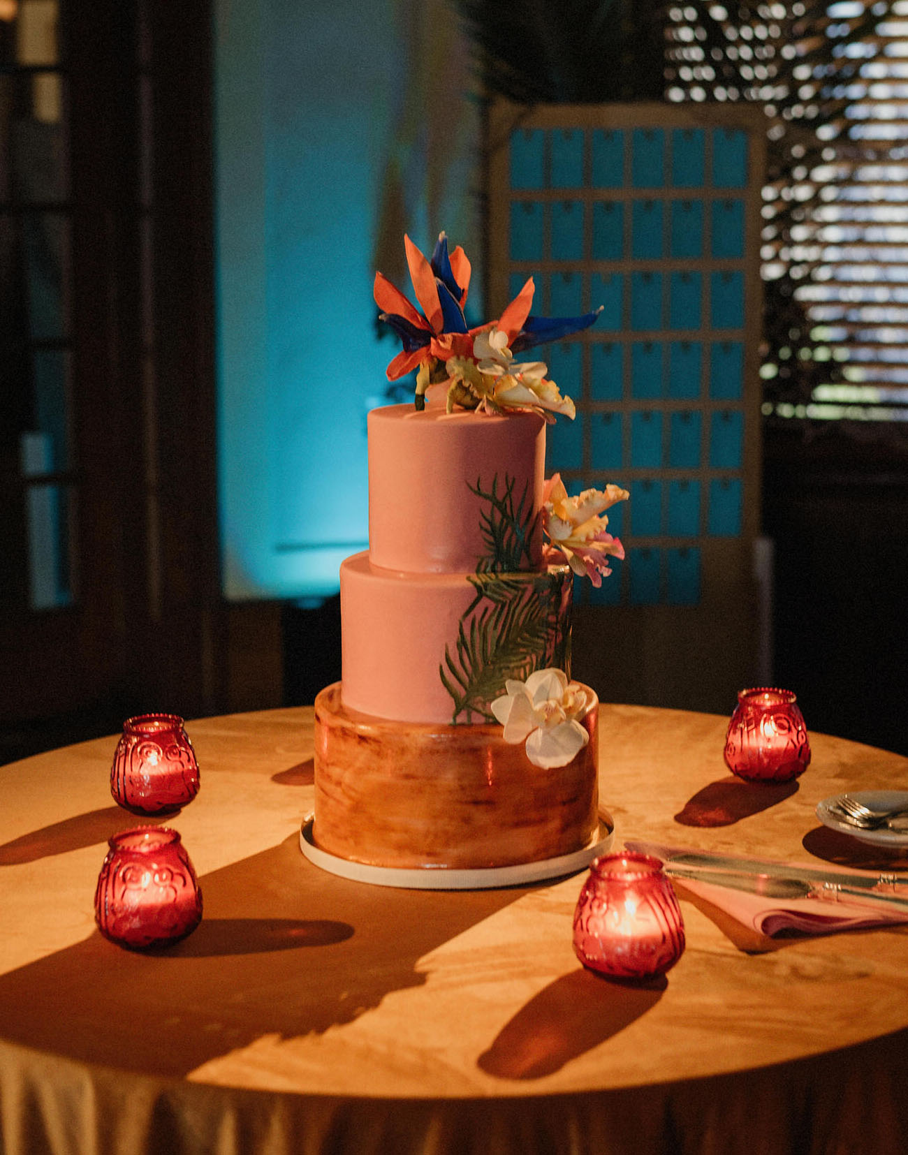 The wedding cake was pink and amber, with large tropical blooms and greenery