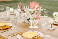 12 The wedding tablescape was done with blush blooms, pink fronds and mustard napkins