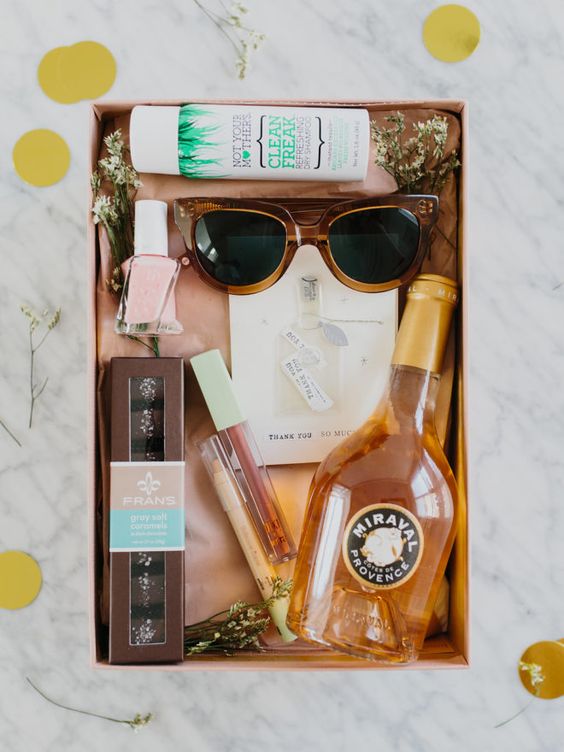 a chic bachelorette gift with some alcohol, chocolate, sunglasses, nail polish and some beauty products