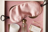 15 a simple and chic bachelorette box with a sleep mask, a candle, a perfume and matches