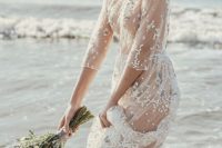 16 a sheer wedding gown with floral embroidery, a high neckline and long sleeves for beach bride