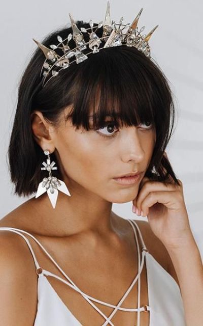 an ultra-modern rhinestone and crystal wedding crown paired with matching earrings for an ultimate look