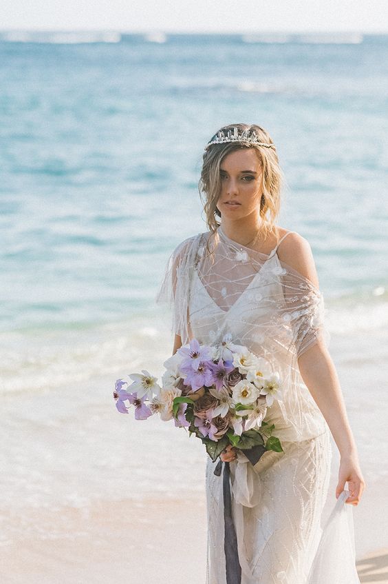 a pretty crystal crown as a statement accessory for a beach bride - very trendy right now