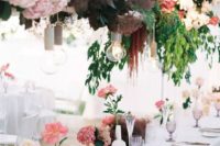 a beautiful wedding reception with a refined overhead installation with greenery, smoke bush, pink and blush blooms