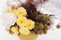 a fall wedding centerpiece in green, white, yellow and burgundy smoke bush is a refined and decadent idea