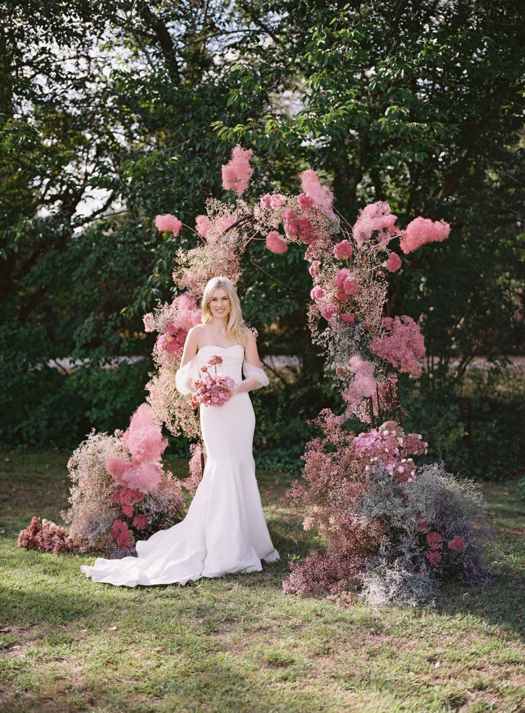 a gorgeous wedding arch done with delicate gypsophila and smoke bush in shades of pink just wows