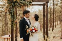a woodland wedding arch with greenery, ferns and smoke bush is a unique idea for a strong natural feel