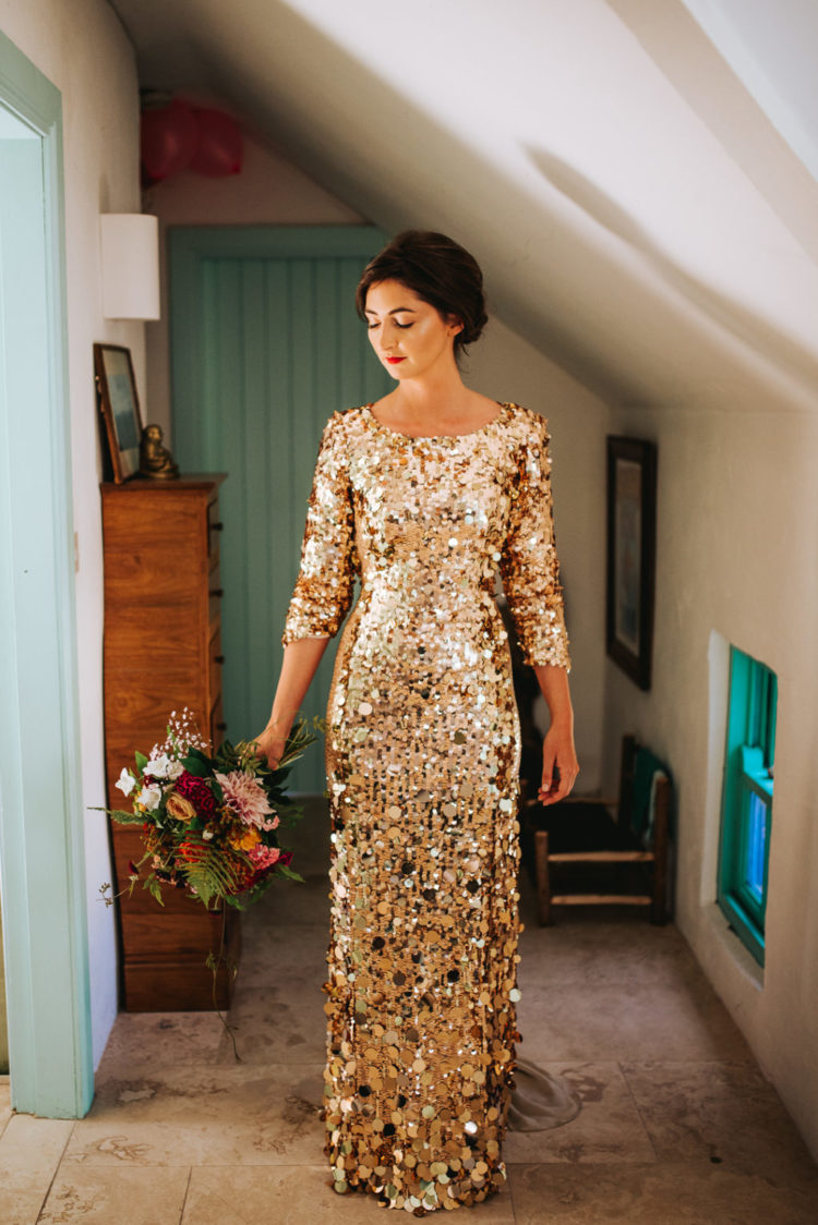The bride was wearing a fantastic gold sequin wedding dress wiht shot sleeves