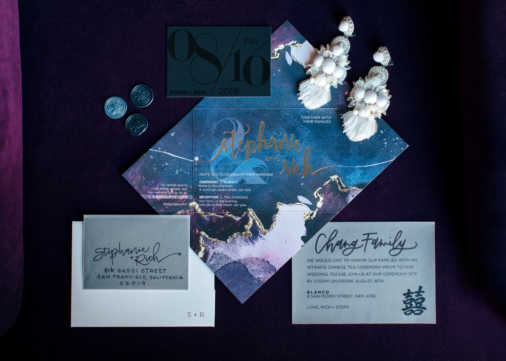 The wedding stationery was done moody, with watercolors and gold leaf