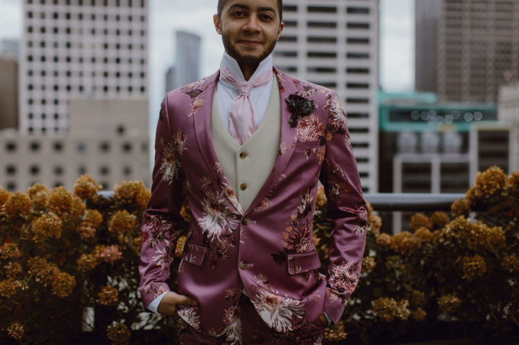 The groom was wearing a pink floral suit, a creamy waistcoat, a pink tie