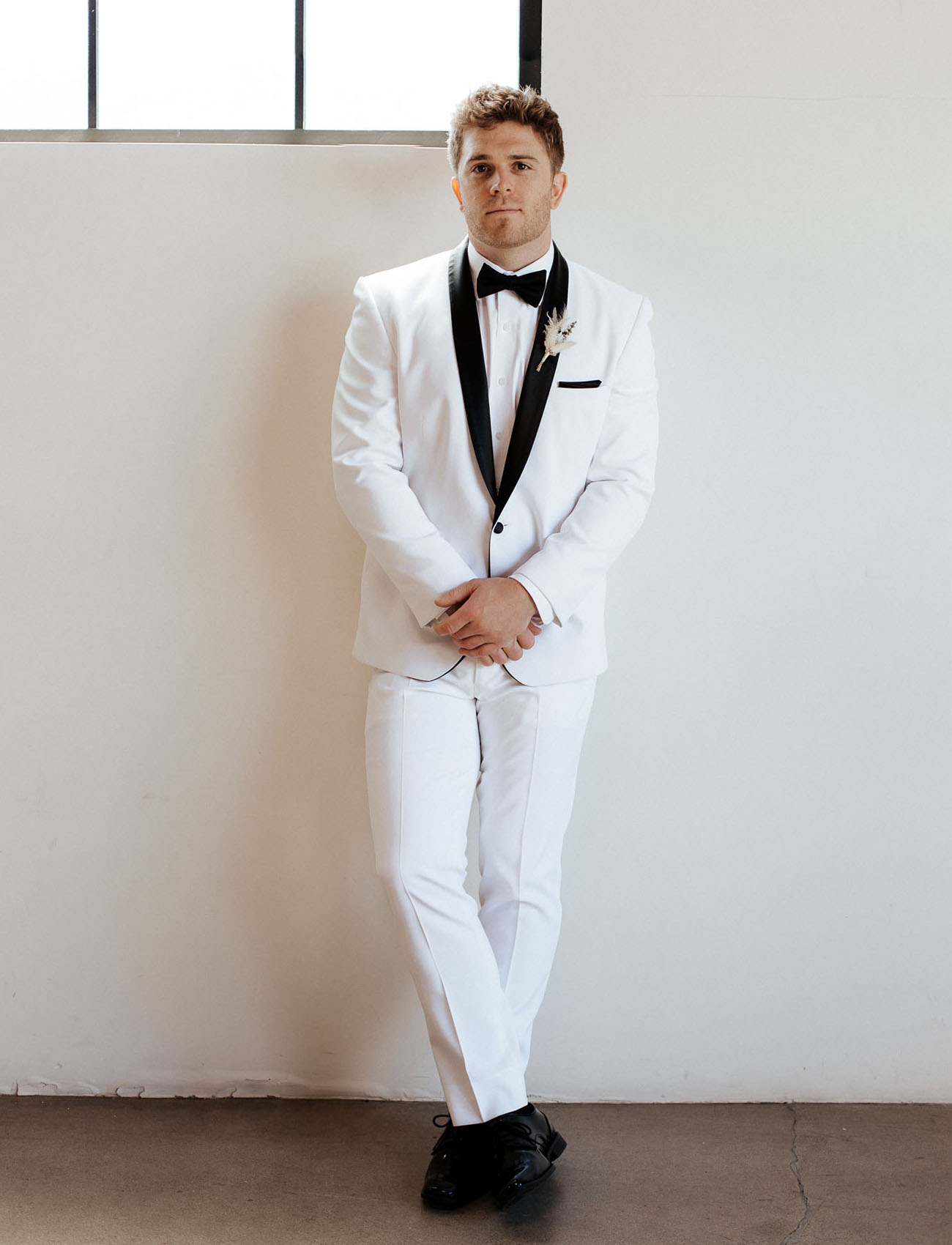 The groom was wearing a white tux with black lapels