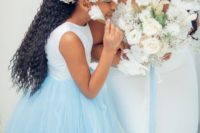 05 The floral girl was wearing a white and ice blue wedding dress and a baby’s breath crown