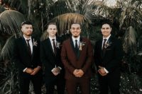 05 The groom was wearing a burgundy tux with black lapels, the groomsmen were rocking black suits